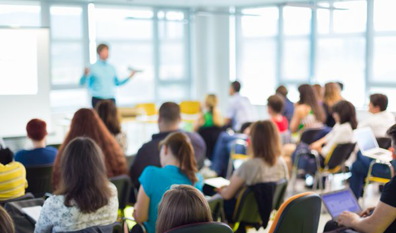 Educator in front of full classroom