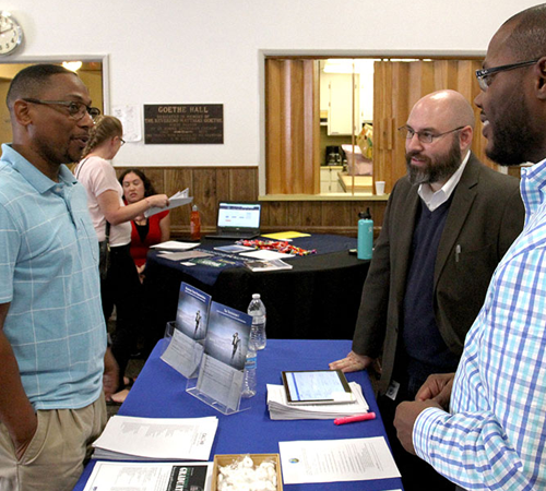 Two Male CDTFA Employees Communicating with a Taxpayer