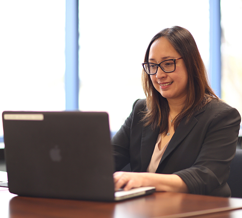 Female CDTFA Employee Typing on Computer